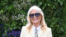 Gaby Roslin wearing a cream suit and purple sunglasses