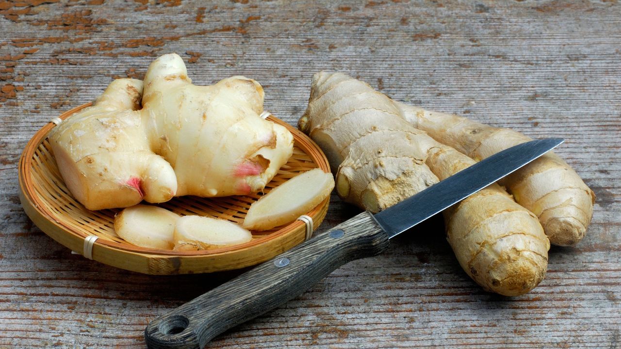 Ginger in a bowl with a wooden knife