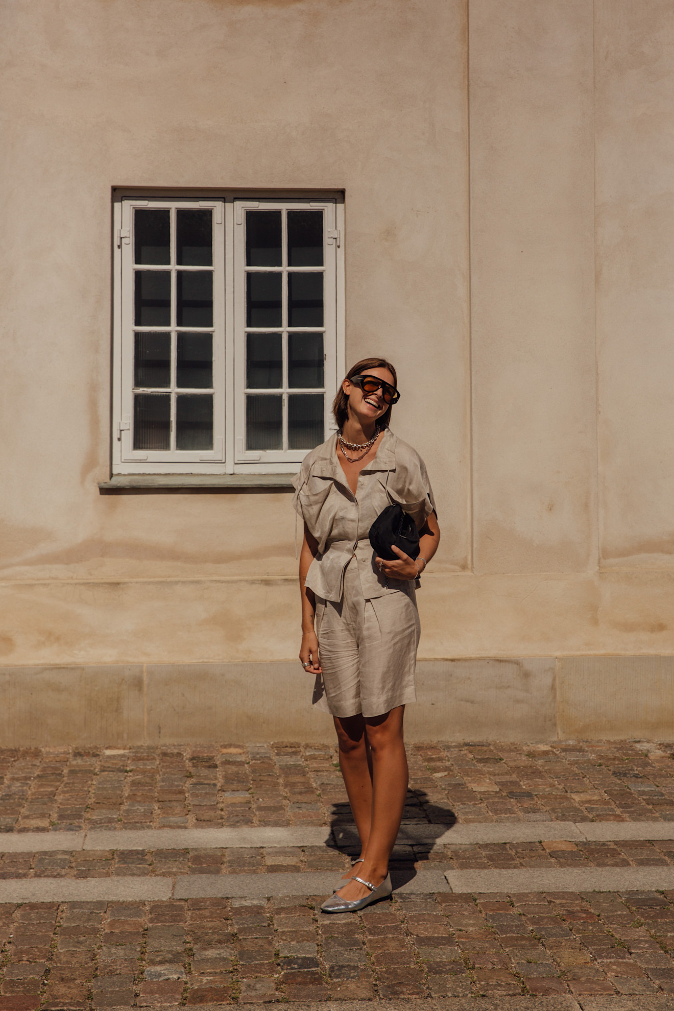 a woman in copenhagen wearing bermuda shorts