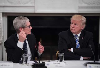 US President Donald Trump listens to Apple CEO Tim Cook speak during an American Technology Council roundtable at the White House in Washington, DC, on June 19, 2017.
