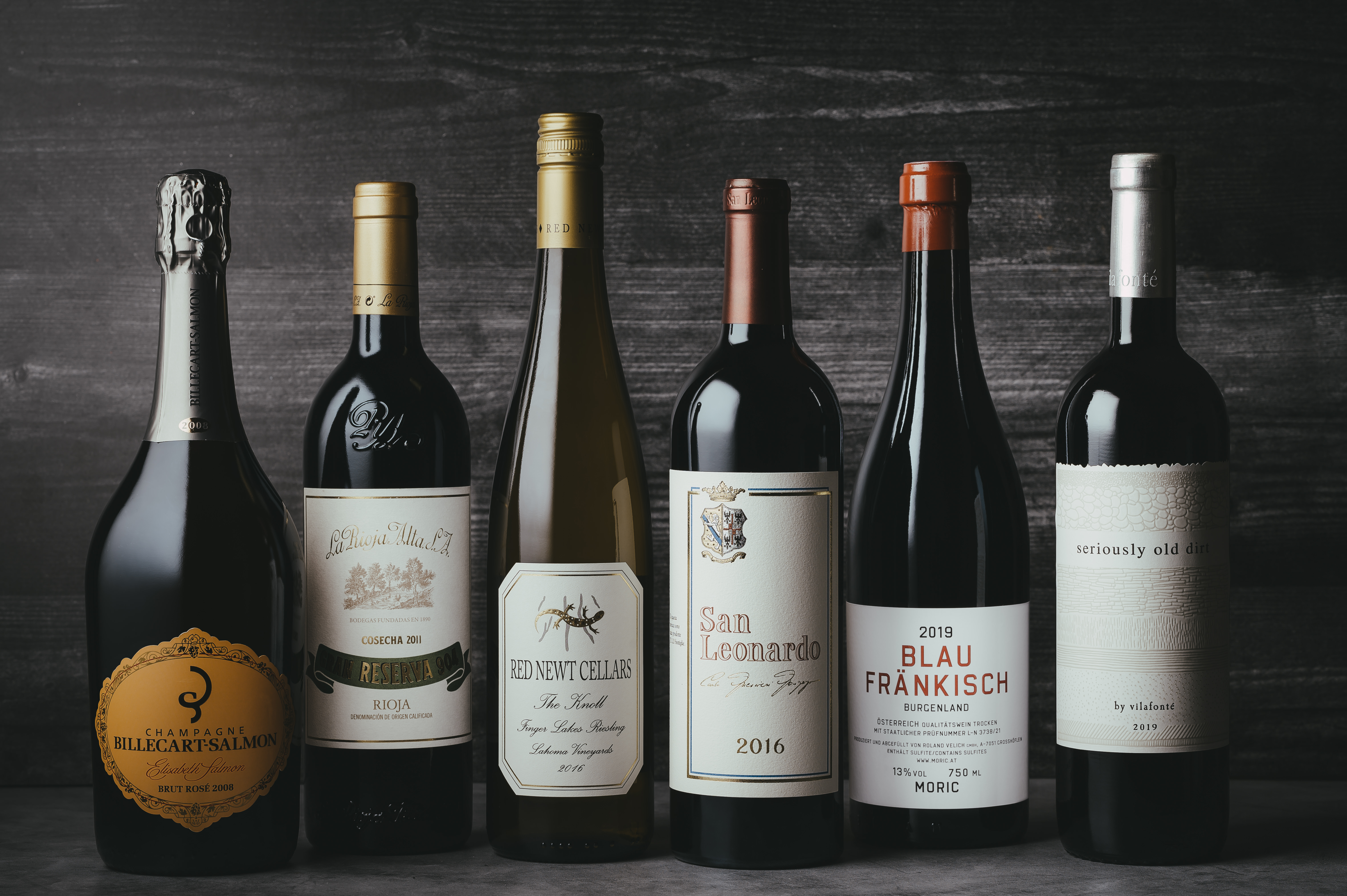 A collection of fine wines lined up side by side