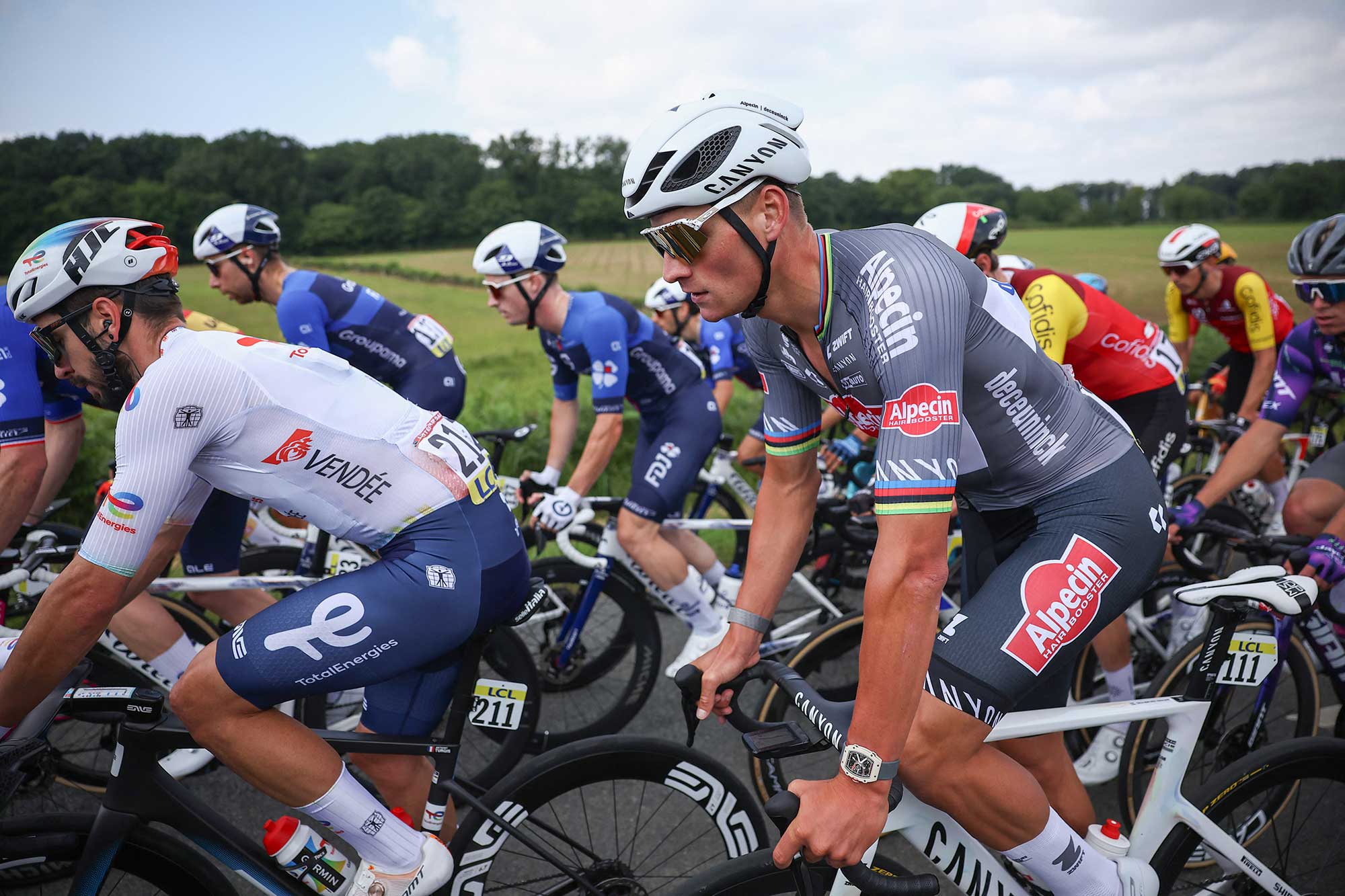 AlpecinDeceunincks Dutch rider Mathieu van der Poel R cycles with the pack of riders during the 1st stage of the 77th edition of the Criterium du Dauphine cycling race 1958 km between Domrat and Montlucon on June 8 2025 Photo by AnneChristine POUJOULAT AFP Photo by ANNECHRISTINE POUJOULATAFP via Getty Images 