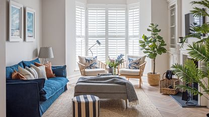 A blue sofa and bay window in a modern family home