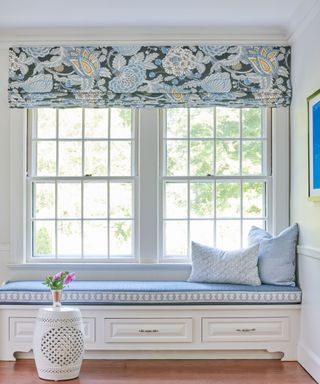 Old money coastal style window seat with a blue and white color scheme