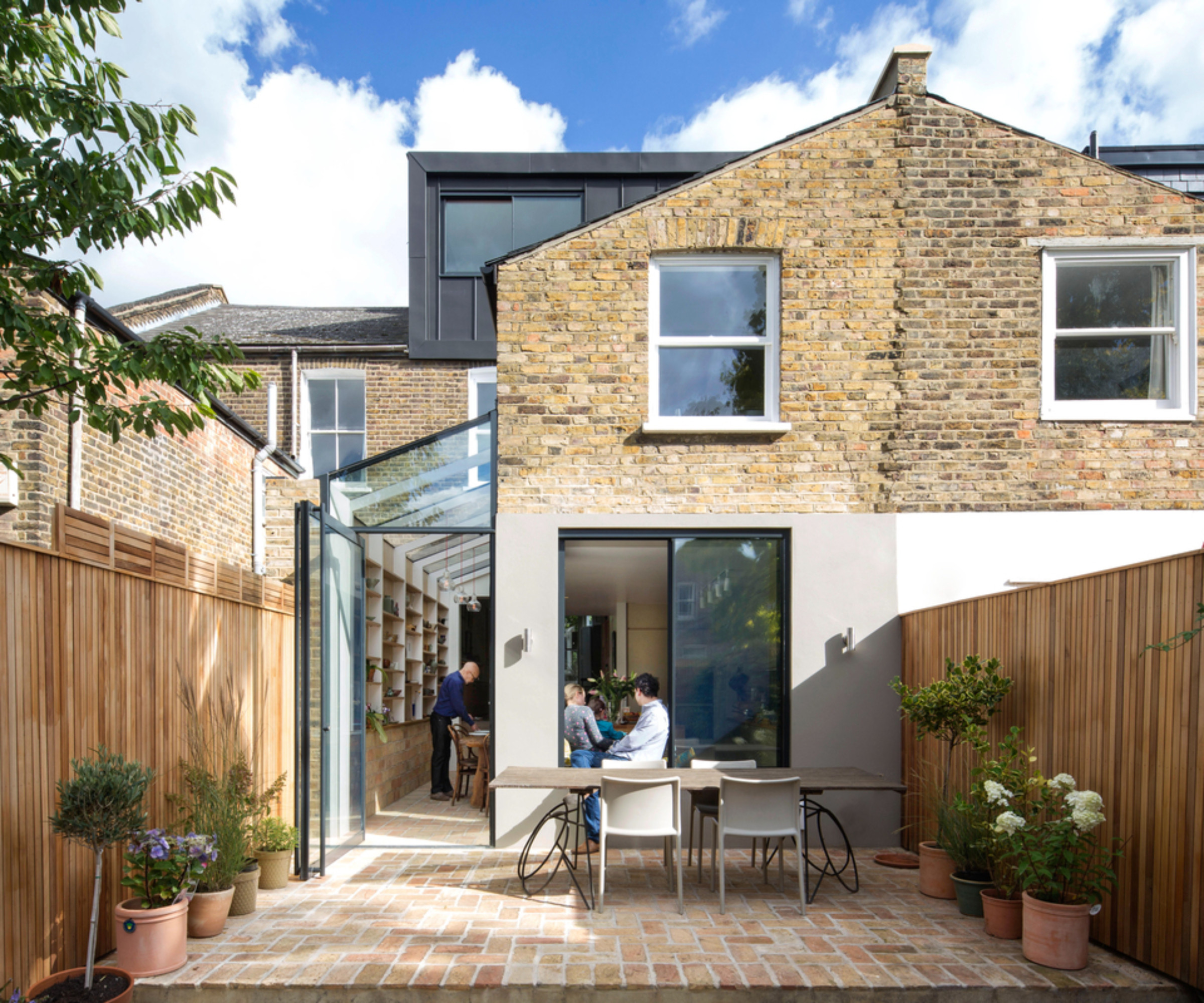 glass side return on rear brick and render extension of terraced house, zinc clad dormer loft extension above