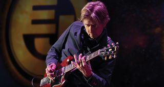 Eric Johnson takes a solo onstage with his Gibson SG