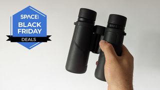 A pair of Nikon Prostaff P3 8x42 binoculars, held in a hand.