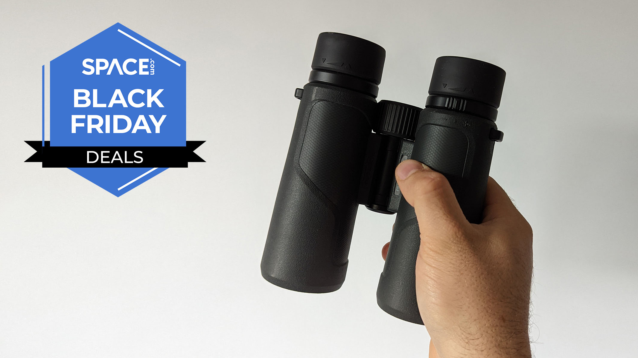 A pair of Nikon Prostaff P3 8x42 binoculars, held in a hand. 