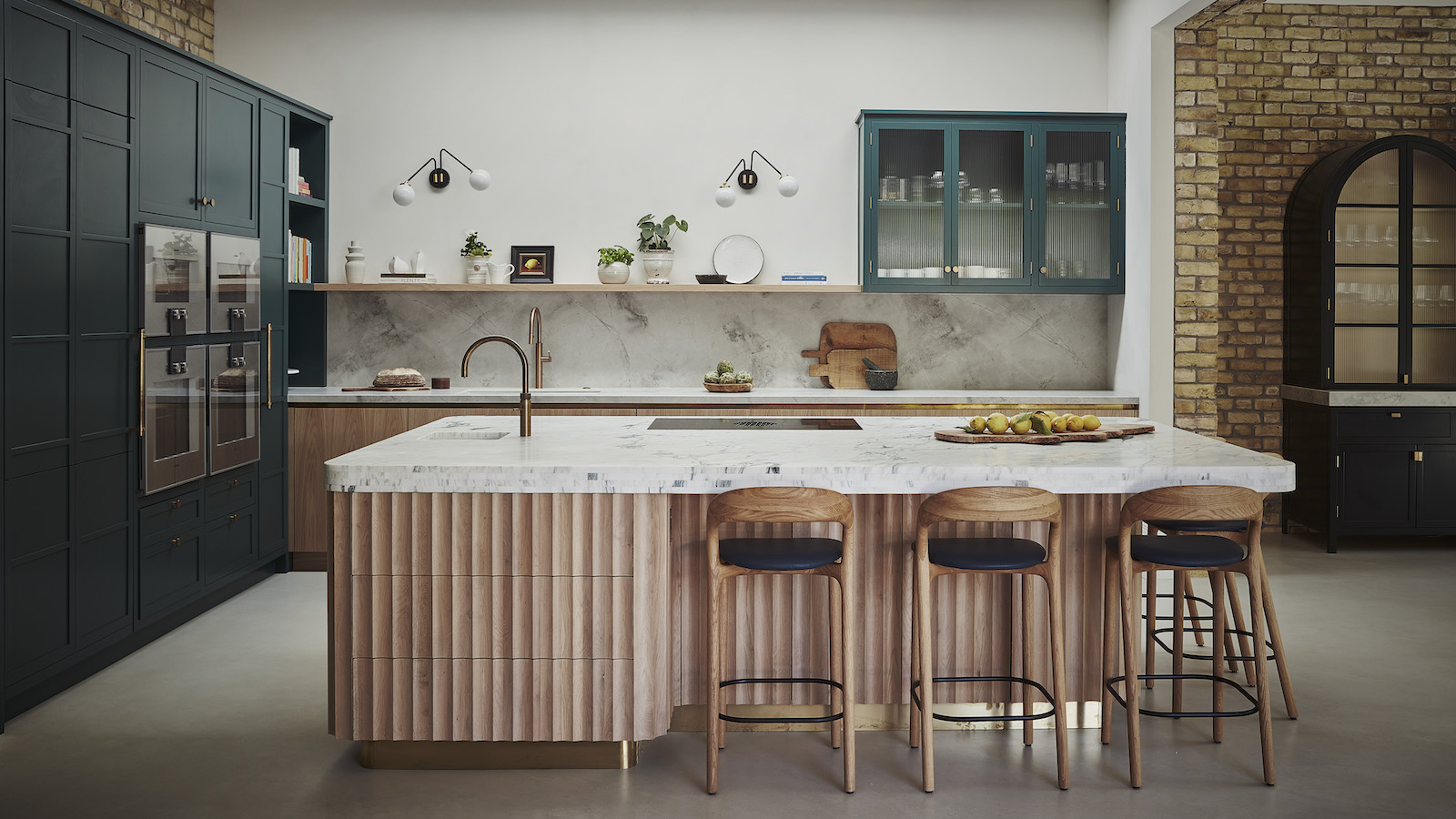 wood kitchen island with ribbed doors and bar stools