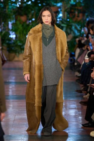 A runway model wears a F/W 2025 TWP outfit.