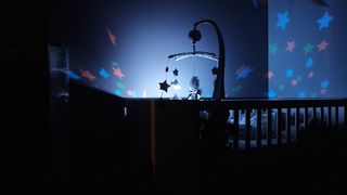 crib mobile in dark room