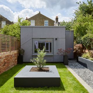 sloping roof house with garden and grass lawn