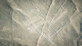 Aerial photo of Nazca lines in Peru. This geoglyph looks like a line drawing of a dog.