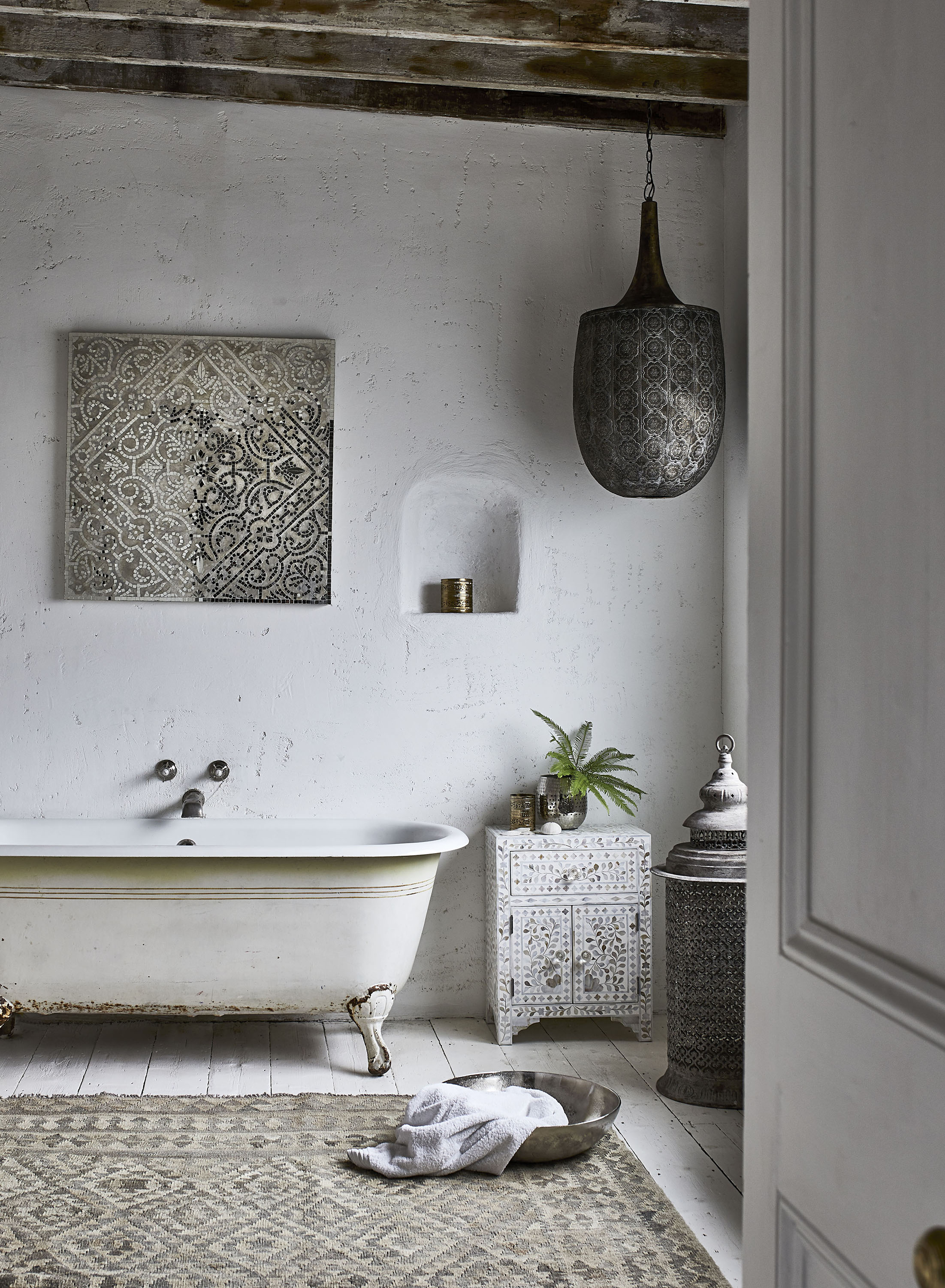 simple folklore trend items in a white bathroom