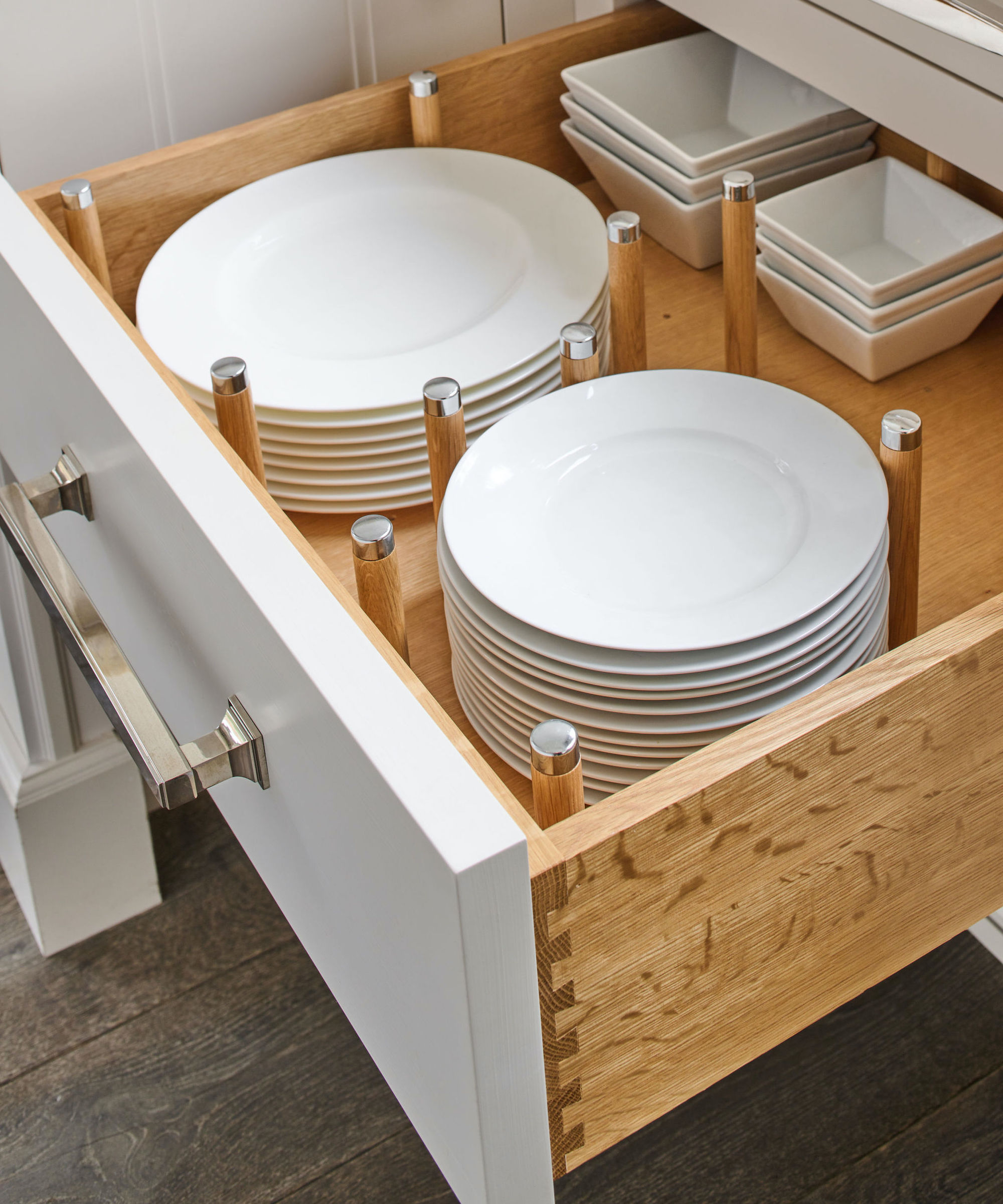 open drawer with white plates inside