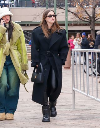 Hailey Bieber wears Saint Laurent trench coat in Aspen