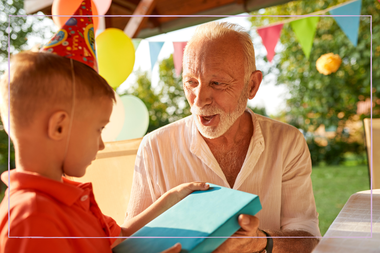 Grandfather giving his grandson a gift