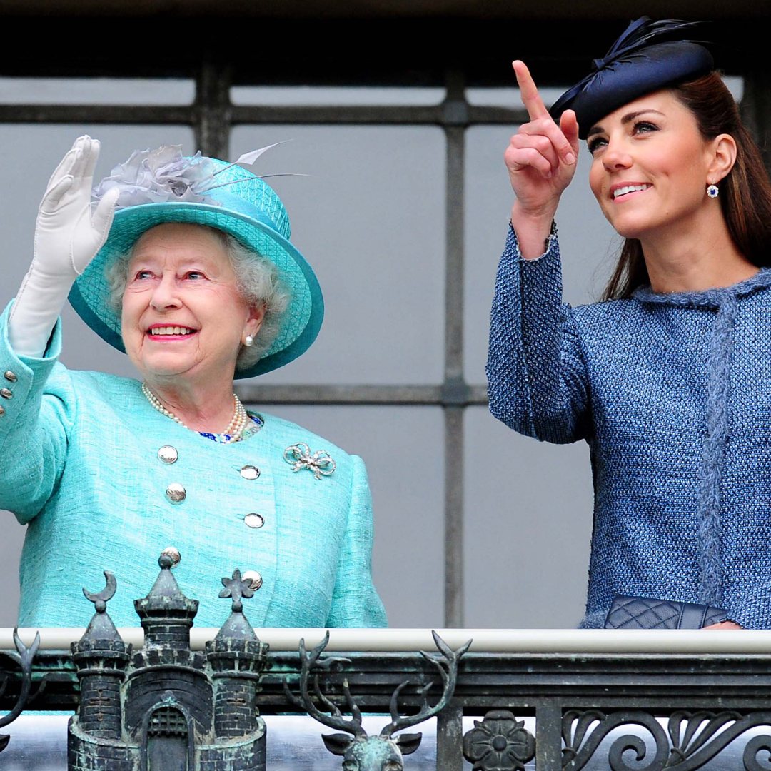 Queen Elizabeth wears a turquoise suit and matching hat while Princess Kate points at the sky and wears a blue coat dress