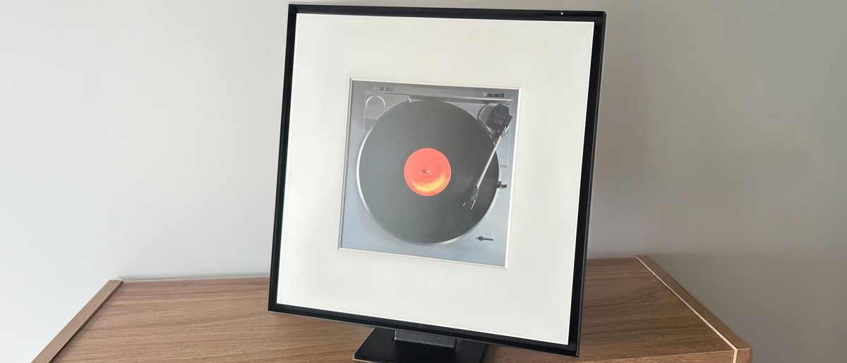 Samsung Music Frame speaker on brown bench top with white background