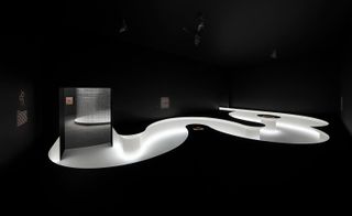 Black room with a winding walkway lit in white from the floor