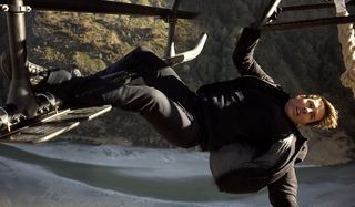 Mission: Impossible - Fallout Tom Cruise Ethan Hunt hanging off of a helicopter's railing