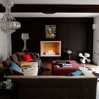 living room with white and dark brown wall brown sofa and painting on wall