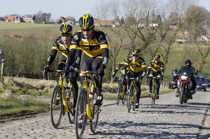 MTN-Qhubeka team members ride the Haaghoek sector of cobbles.