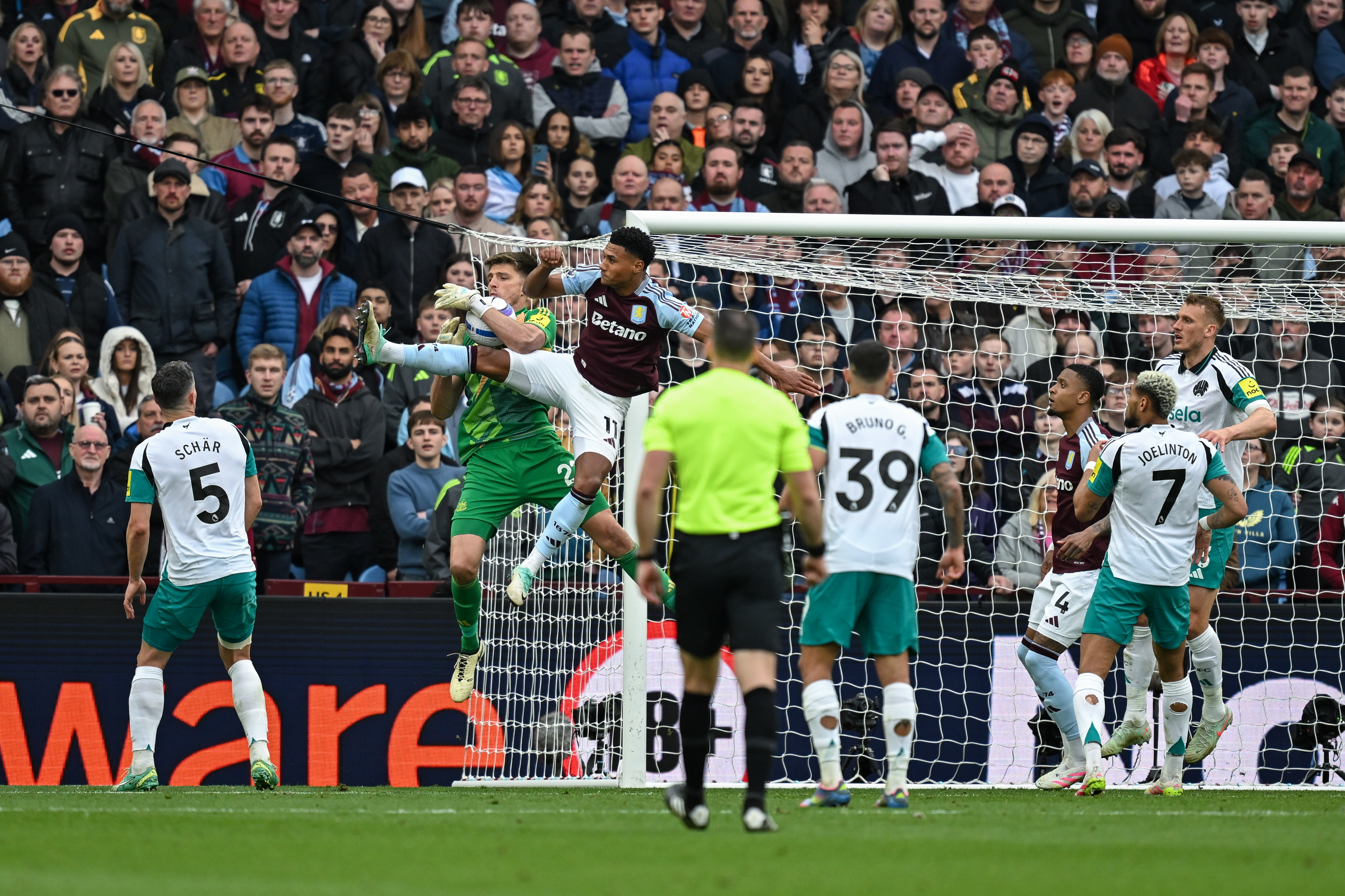 Nick Pope claims the ball ahead of Aston Villa's Ollie Watkins