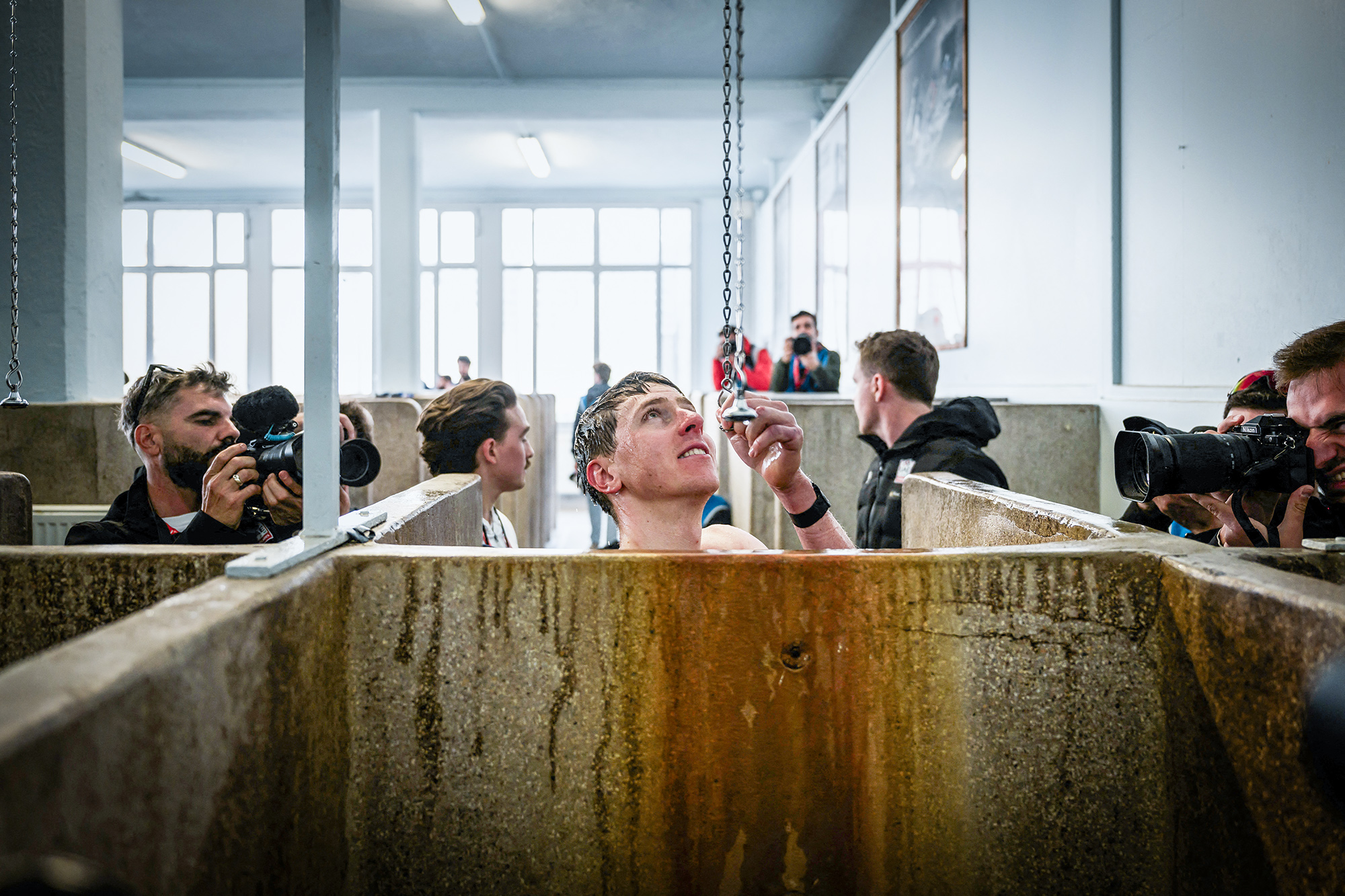 TOPSHOT - UAE Team Emirates&#039; Slovenian rider Tadej Pogacar showers at the end of the 122nd edition of the Paris-Roubaix one-day classic cycling race, 259,2 km between Compiegne and Roubaix, northern France on April 13, 2025. (Photo by JEFF PACHOUD / AFP) (Photo by JEFF PACHOUD/AFP via Getty Images)