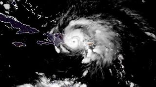 swirl of white clouds over outline of the Dominican Republic and Puerto Rico