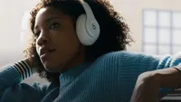 Best Apple headphones: Woman wearing Beats headphones