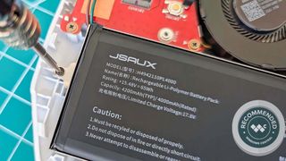 JSAUX ROG Ally Battery getting installed in ROG Ally. A Windows Central Recommended badge is on the bottom right corner.