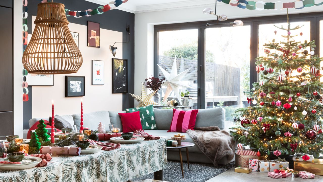 Living room with decorated Christmas tree, presents, and cushions