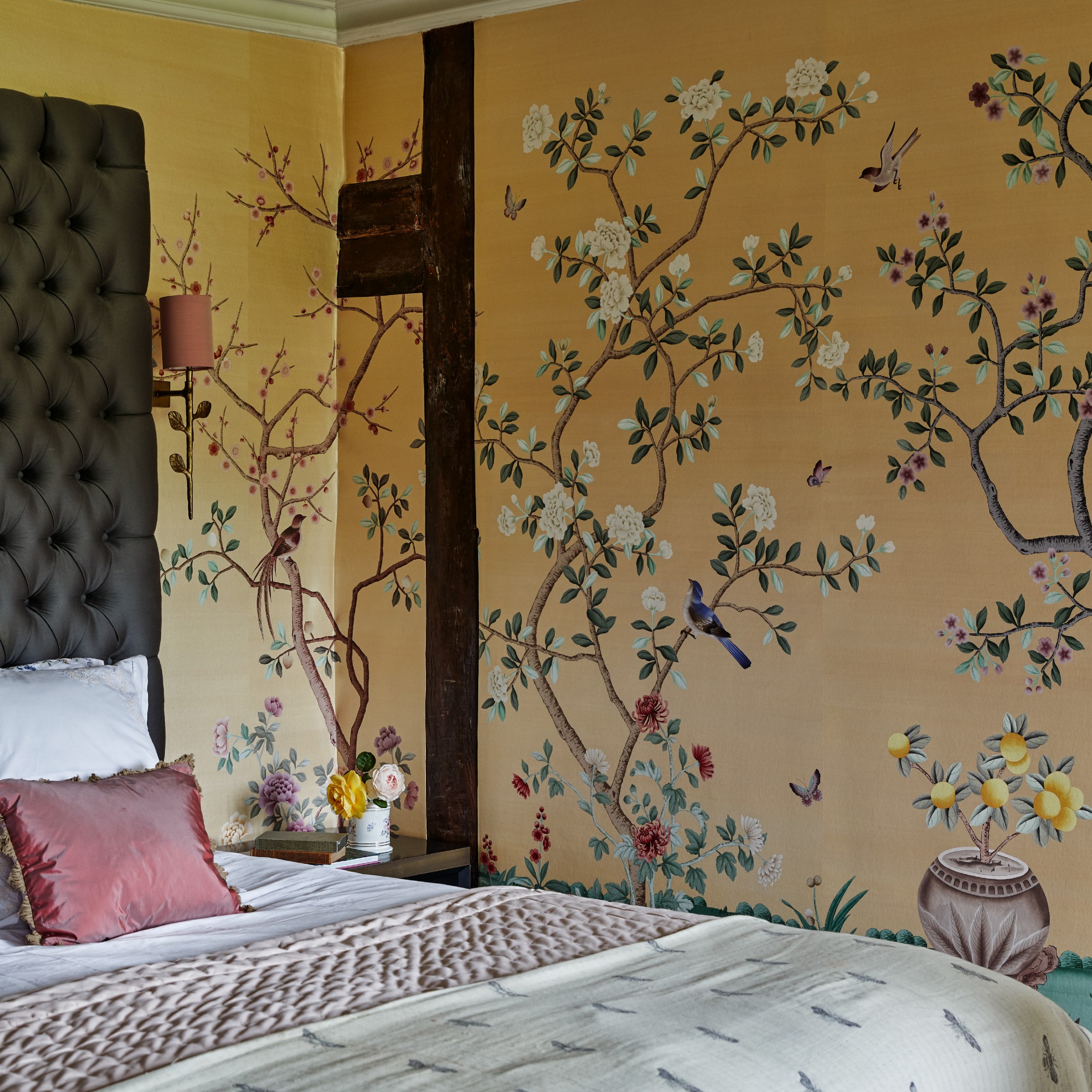 A bedroom with the walls covered in an artistic floral mural