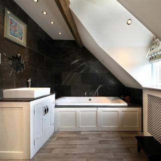 Bathroom with wash basin and wooden flooring