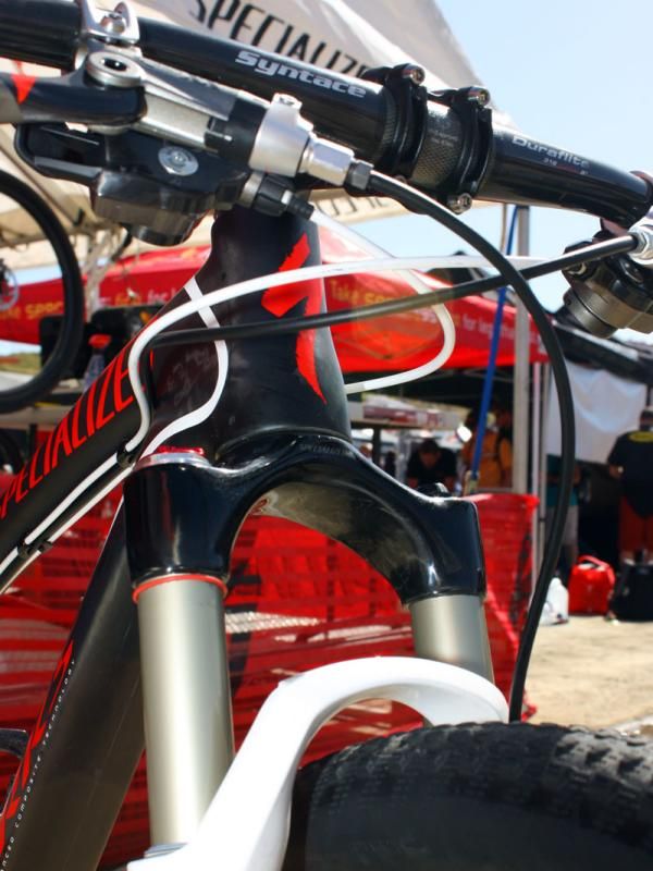 A tapered carbon fiber crown and steerer assembly is bonded to the Reba upper tubes.