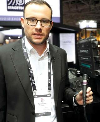Fabio Röllin, product manager for optical fiber  solutions at Neutrik, with a Neutrik opticalCON  Dragonfly connector that has an IP67 environmental  rating.