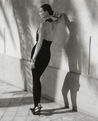 Model wears black against backdrop of Moroccan hotel