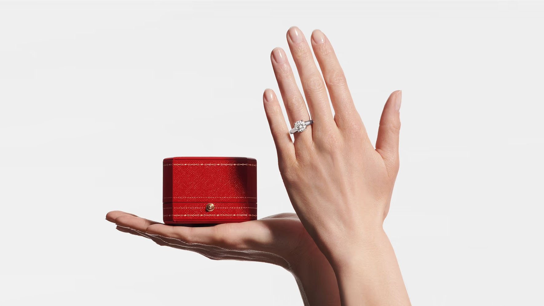 Cartier round engagement ring and red ring box