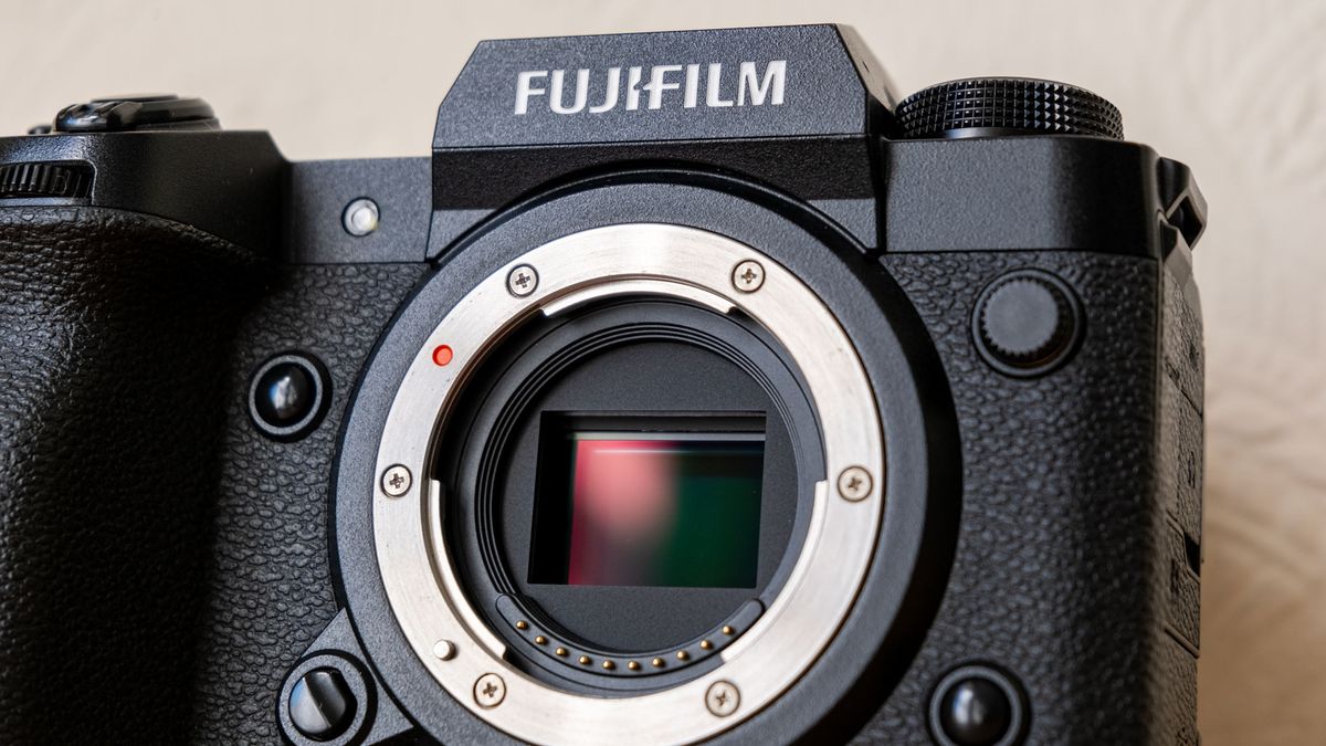 A close-up of the front of the Fujifilm X-H2, with the sensor appearing red and green