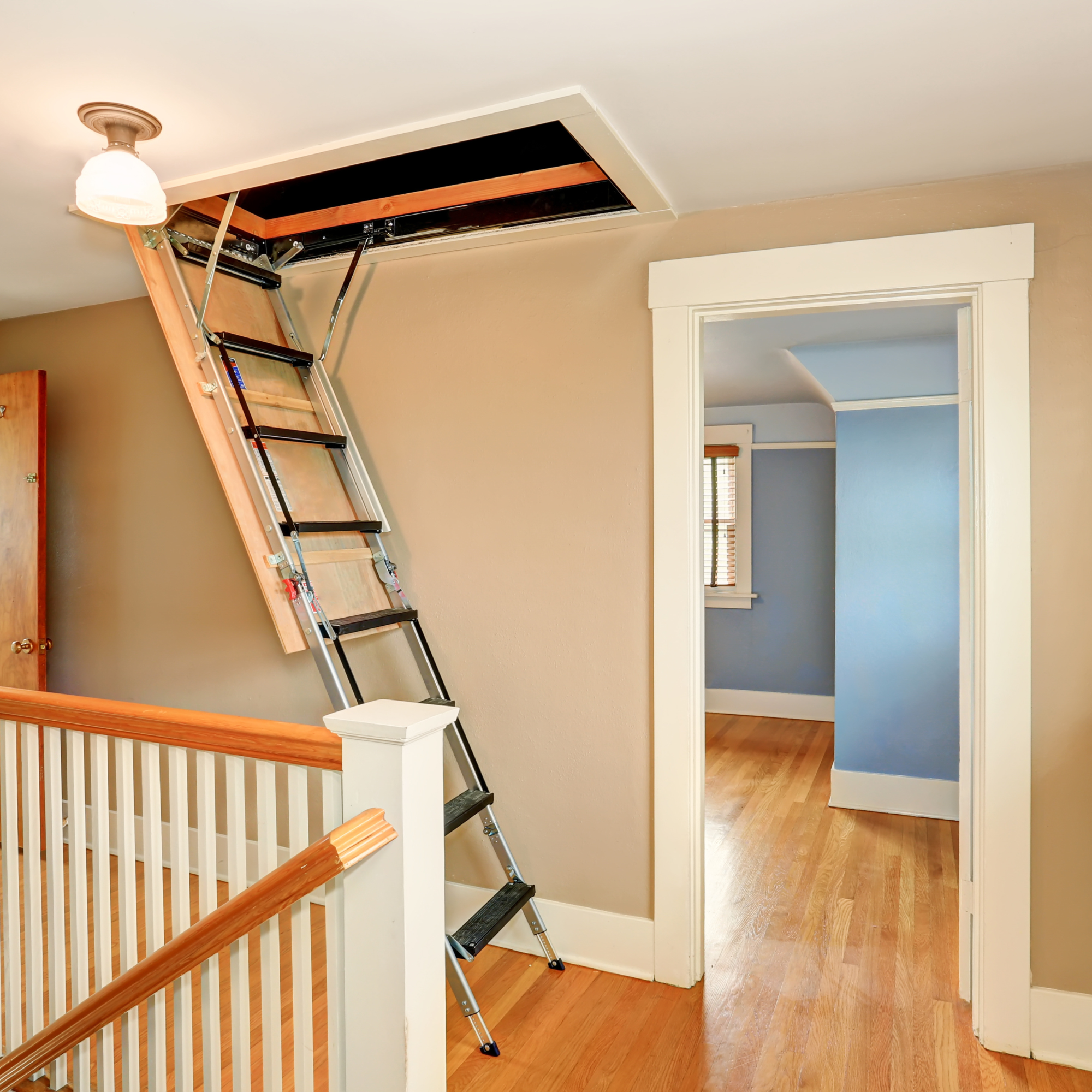 Open loft hatch with ladder leading down to the landing.