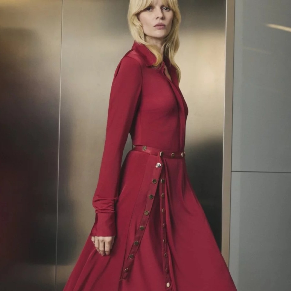 Model wearing a deep red dress and a red belt with chrome accents sold at Karen Millen