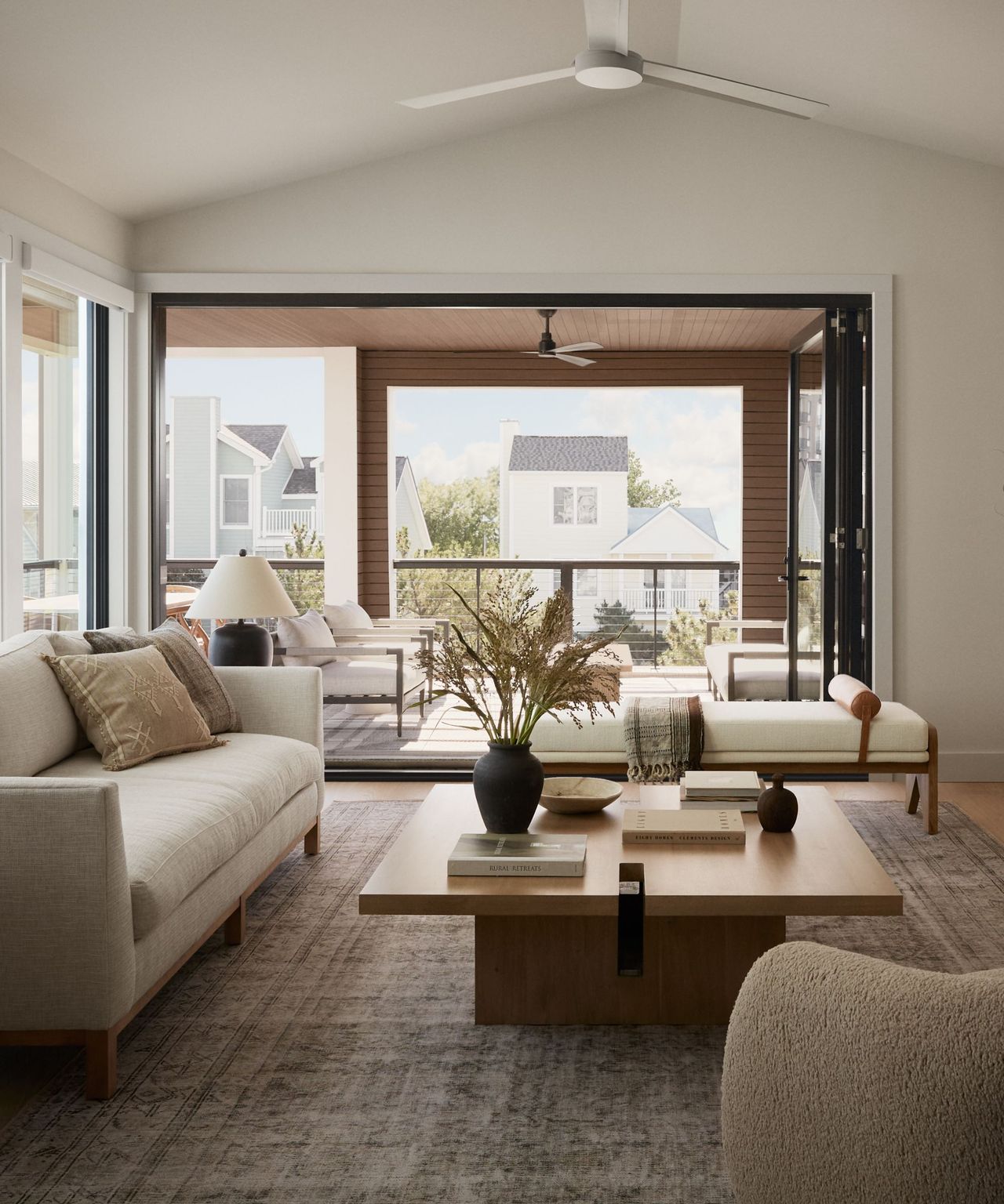A coastal modern living room opening up to an outdoor living area