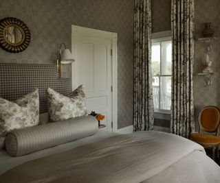 bedroom with wallpaper and patterned curtains