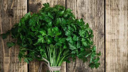 Parsley on wooden chopping board