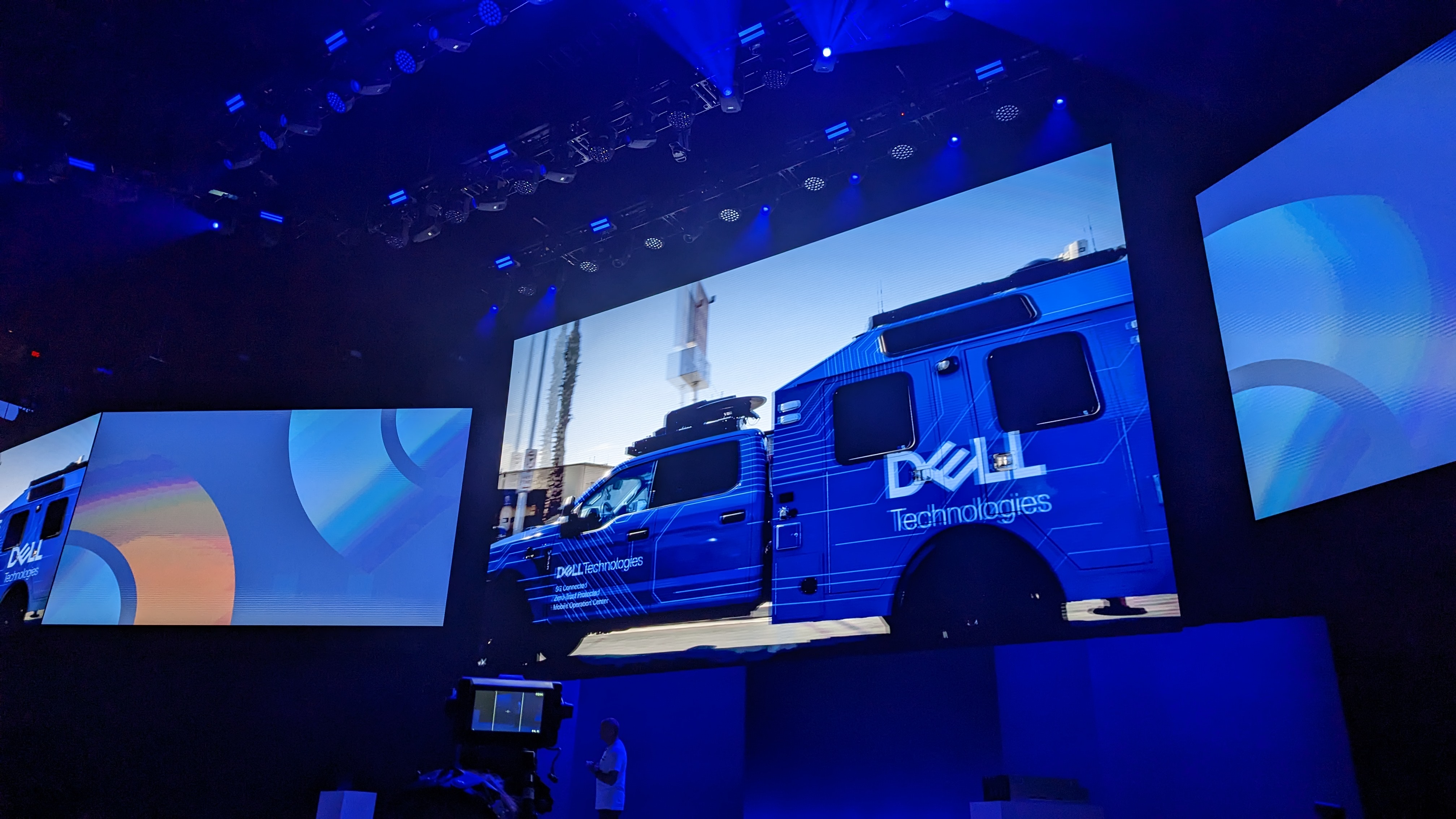 A screen on the Dell Technologies World keynote stage, showing a blue truck with the Dell logo on its side driving around Las Vegas.