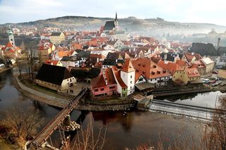 Fog creeps over a small town in the South Bohemian region of the Czech Republic. The photo was taken from a nearby castle.