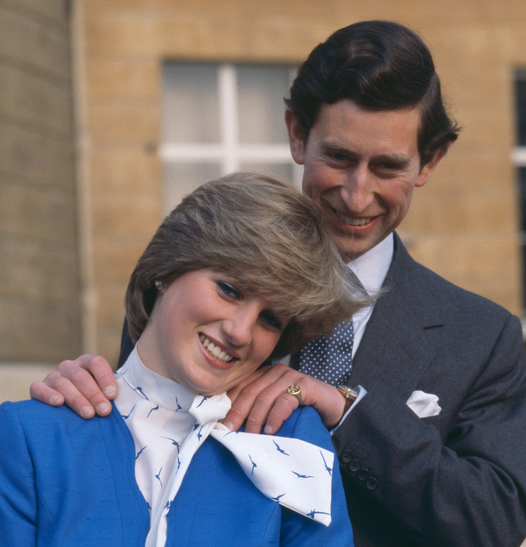 Prince Charles putting his hands on Princess Diana&#039;s shoulders during their engagement photoshoot in 1981