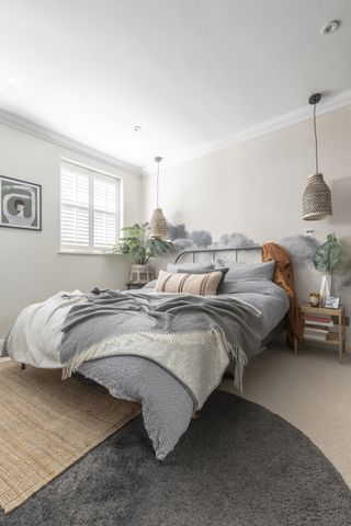 Neutral bedroom with metal bedframe and grey bedding