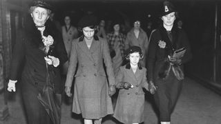 Princess Elizabeth and Princess Margaret with Lady Helen Graham and Miss Marion Crawford ('Crawfie'- Princess Elizabeth's governess) after their first ride on the Underground